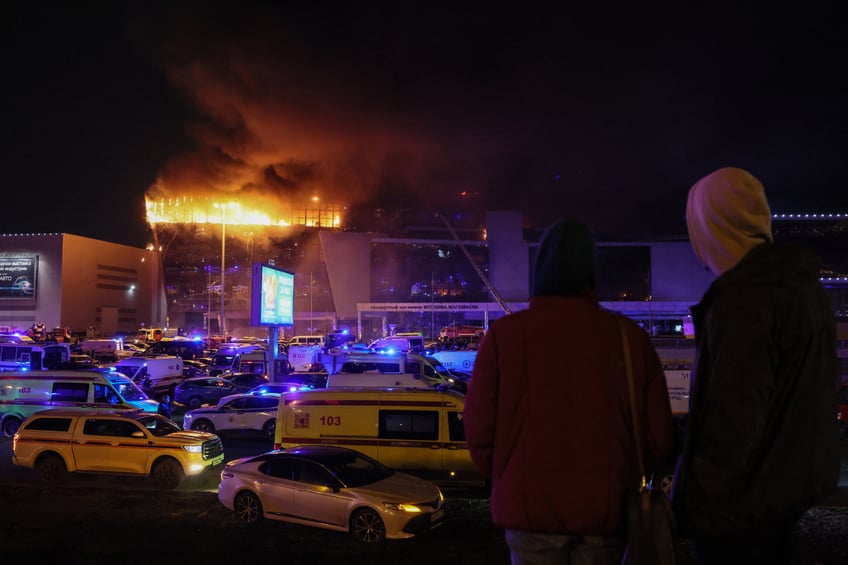 Emergency services vehicles are seen outside the burning Crocus City Hall concert hall following the shooting incident in Krasnogorsk, outside Moscow, on March 22, 2024. Gunmen opened fire at a concert hall in a Moscow suburb on March 22, 2024 leaving dead and wounded before a major fire spread through the building, Moscow's mayor and Russian news agencies reported. (Photo by STRINGER / AFP) (Photo by STRINGER/AFP via Getty Images)