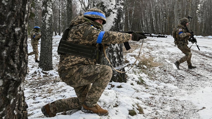 Ukrainian soldiers with assault rifles