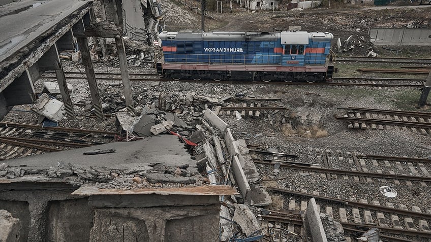 A locomotive passes under a destroyed bridge on a heavily damaged railway track in Pokrovsk, Ukraine, on Nov. 16. 