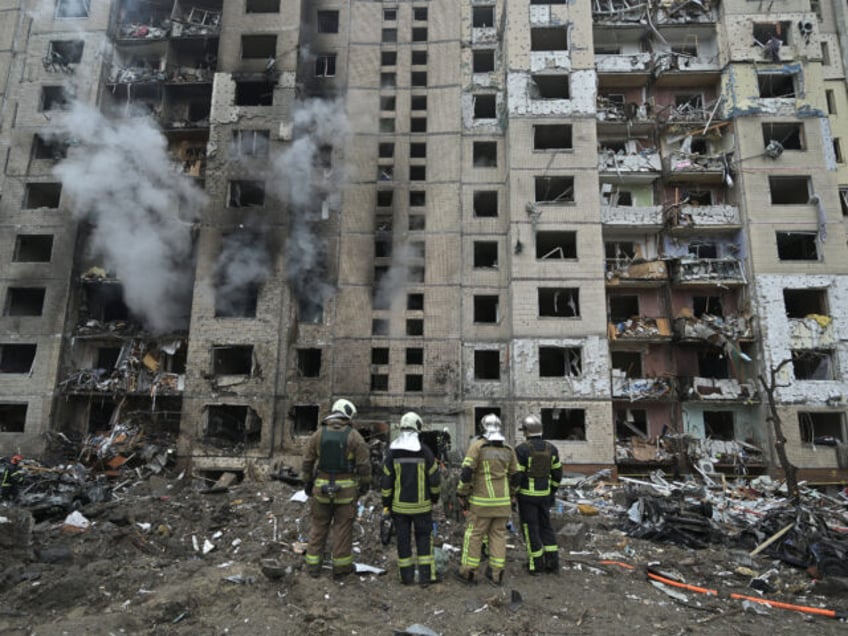 TOPSHOT - Firefighters work in a multi-storey residential building destroyed by a missile attack in central Kyiv, on January 2, 2024, amid the Russian invasion of Ukraine. Russian strikes on Ukraine's capital, Kyiv, and the northeastern city of Kharkiv killed at least five people. Russian President Vladimir Putin on January …