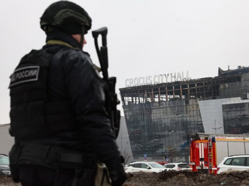 TOPSHOT - A law enforcement officer patrols the scene of the gun attack at the Crocus City