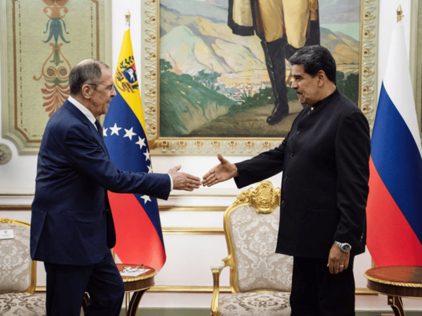 Sergei Lavrov, Russia's foreign minister, left, shakes hands with Nicolas Maduro, Venezuel