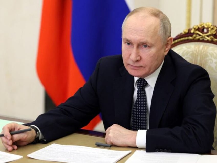 In this pool photograph distributed by Russian state owned agency, Russian President Vladimir Putin chairs a meeting with Russia's Government members via video link in Moscow, on January 17, 2024. (Photo by Gavriil Grigorov / POOL / AFP) / Editor's note : this image is distributed by Russian state owned …