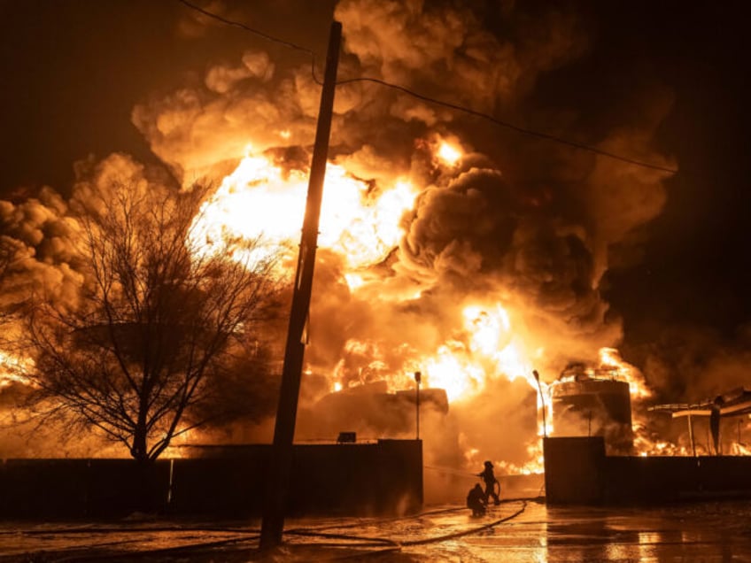 Firefighters extinguish a fire after a Russian attack on a residential neighborhood in Kha