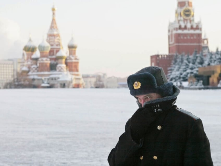 MOSCOW - JANUARY 7: A Russian police officer, braving the bitter cold, patrols Red Square with the Kremlin in the background January 7, 2003 in Moscow. Temperatures fell to 27 degrees below zero Celcius (17 below zero Fahrenheit) in Moscow. (Photo by Oleg Nikishin/Getty Images)