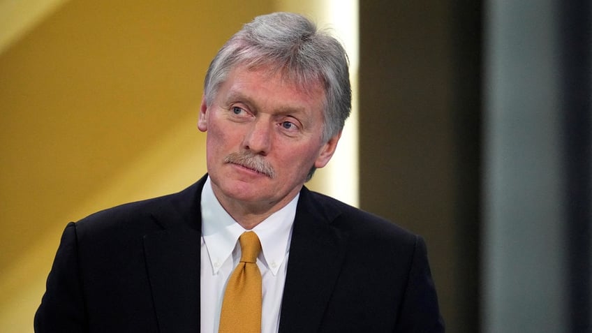 Kremlin spokesman Dmitry Peskov wears a dark suit with a white shirt and yellow tie at Russian President Vladimir Putin's annual press conference in Moscow, Russia, on December 14, 2023.