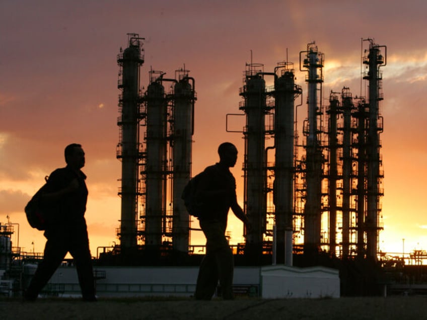 Cuban workers walk along the new Venezue