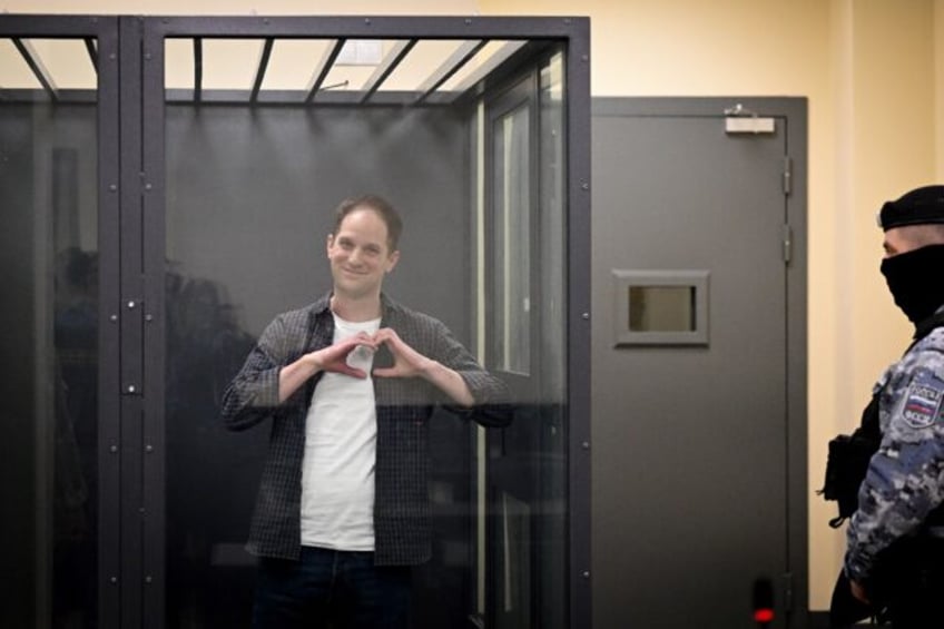 US journalist Evan Gershkovich, arrested on espionage charges, shapes a heart with his han