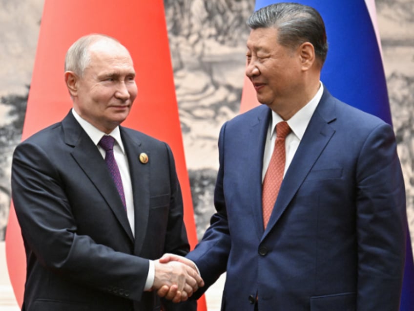 TOPSHOT - In this pool photograph distributed by the Russian state agency Sputnik, Russia's President Vladimir Putin and China's President Xi Jinping shake hands during a signing ceremony following their talks in Beijing on May 16, 2024. (Photo by Sergei BOBYLYOV / POOL / AFP) / ** Editor's note : this image is distributed by Russian state owned agency Sputnik ** (Photo by SERGEI BOBYLYOV/POOL/AFP via Getty Images)