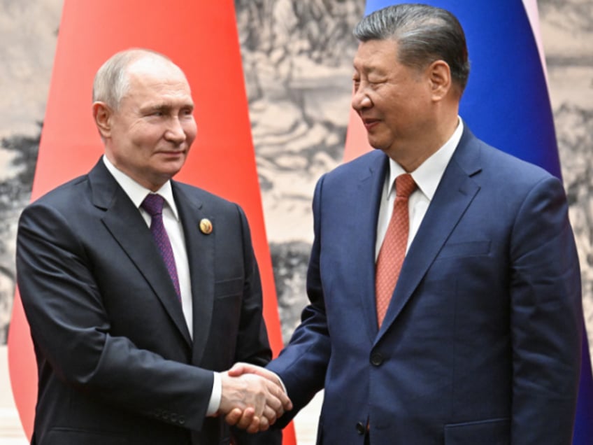 TOPSHOT - In this pool photograph distributed by the Russian state agency Sputnik, Russia's President Vladimir Putin and China's President Xi Jinping shake hands during a signing ceremony following their talks in Beijing on May 16, 2024. (Photo by Sergei BOBYLYOV / POOL / AFP) / ** Editor's note : this image is distributed by Russian state owned agency Sputnik ** (Photo by SERGEI BOBYLYOV/POOL/AFP via Getty Images)