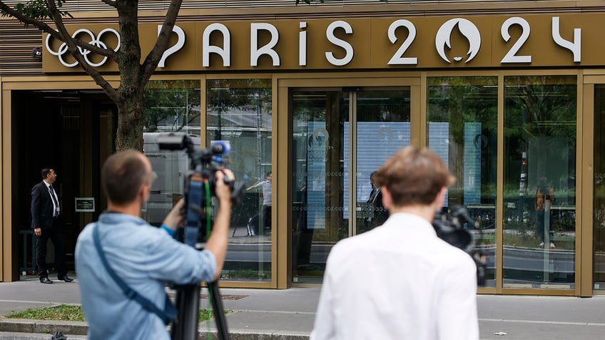 Reporters outside an Olympics office