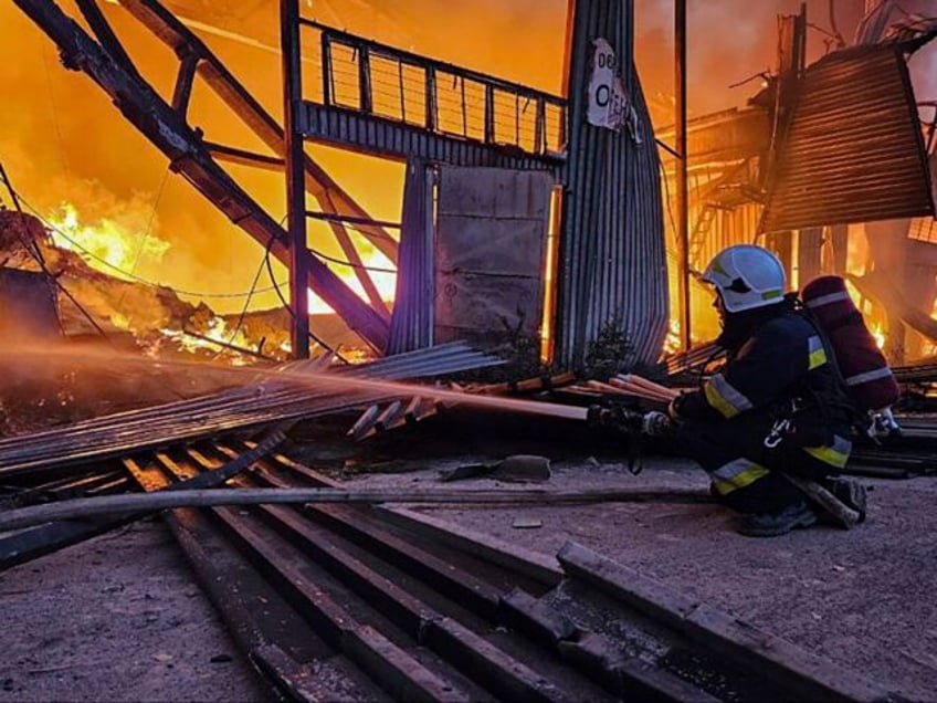 russian drone attack on a city in western ukraine sparks an inferno at a warehouse and kills 1