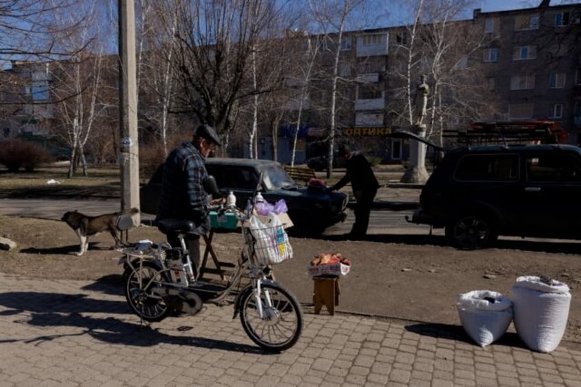 A man buys food at a street market in Kostyantynivka