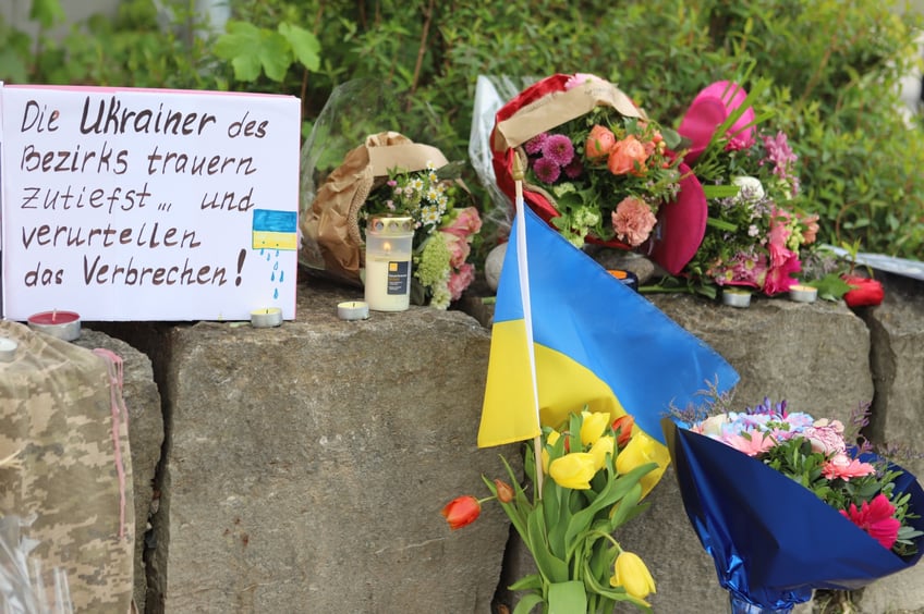 28 April 2024, Bavaria, Murnau: Flowers and a small Ukrainian flag were laid at the site of a shopping center where two men from Ukraine were killed on Saturday evening (27.04.2024). The police were able to arrest a man who is considered an urgent suspect. He is a 57-year-old Russian man. Photo: Constanze Wilz/dpa (Photo by Constanze Wilz/picture alliance via Getty Images)