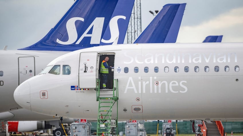 Worker on Scandinavian Airlines airplane