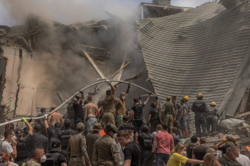 Emergency and rescue personnel along with others clear the rubble of the destroyed building of Ohmatdyt Children's Hospital following a Russian missile attack in the Ukrainian capital of Kyiv on July 8, 2024, amid Russian invasion in Ukraine. Russia launched more than 40 missiles at several cities across Ukraine on July 8, 2024 in an attack that killed at least 20 people and smashed into a children's hospital in Kyiv, officials said. (Photo by Roman PILIPEY / AFP) (Photo by ROMAN PILIPEY/AFP via Getty Images)