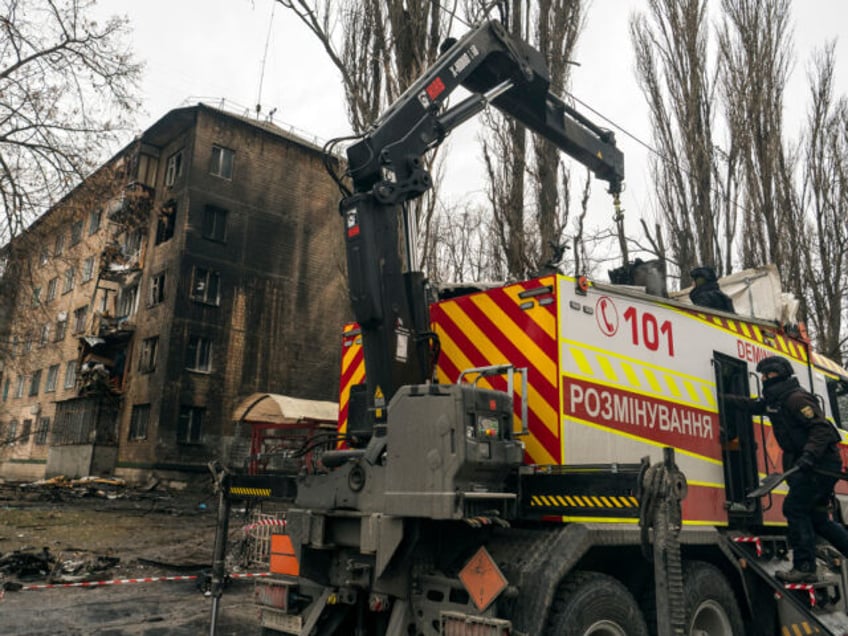 Explosives experts are loading parts of a Russian cruise missile onto a special vehicle after a massive Russian missile attack in Kyiv, Ukraine, on January 23, 2024. (Photo by Maxym Marusenko/NurPhoto via Getty Images)