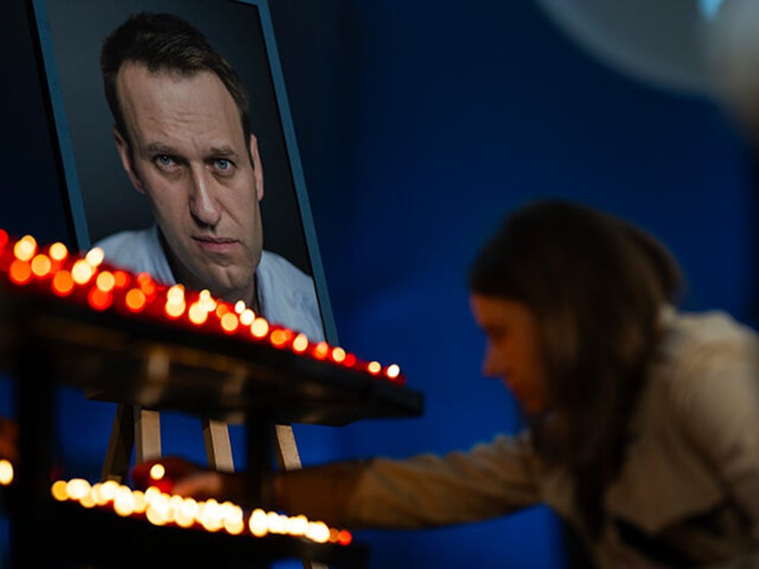 04 June 2024, Berlin: A visitor lights a candle at the end of a service in St. Mary's Chur