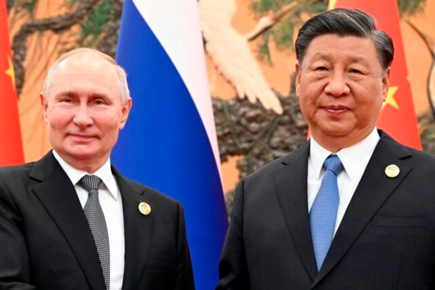 russian president putin and chinese leader xi meet in beijing and call for close policy coordination