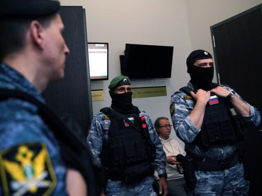 Law enforcement officers stand guard in a Moscow courtroom on September 26, 2023 during th