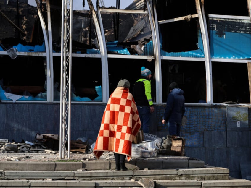 KHERSON, UKRAINE - DECEMBER 5: People look for surviving belongings at a humanitarian center destroyed by Russian missiles on December 5, 2023 in Kherson, Ukraine. On the night of December 4, the Russian military fired at a humanitarian center in Kherson using S-300 missile systems. As a result of the …