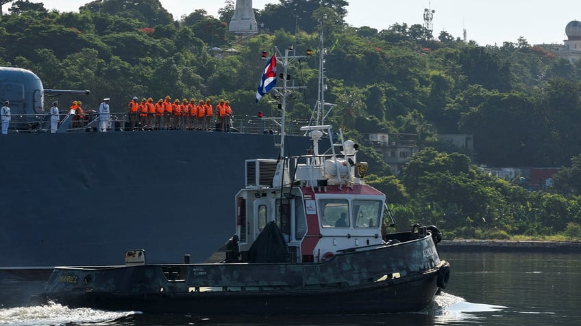 cuban tugboat guides russian ship