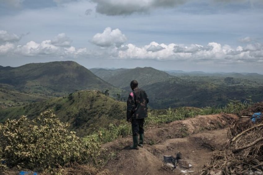 A Congolese soldier stands at a frontline military position above the town of Kibirizi, co