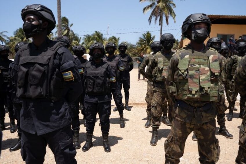 Rwandan police (left) pictured alongside Mozambican troops in 2021