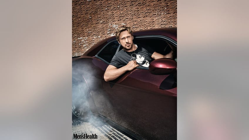 Ryan Gosling sitting in a car with head out the window
