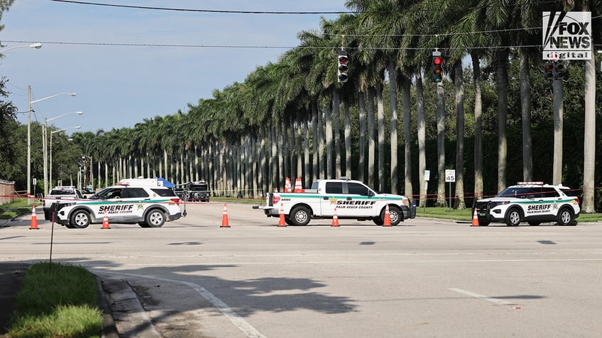 sheriff's office SUVs blocking road