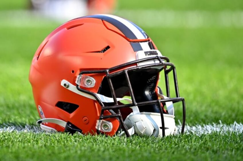 On a football field sits a helmet of the NFL Cleveland Browns, who lost a legend when former quarterback Frank Ryan passed away at age 87