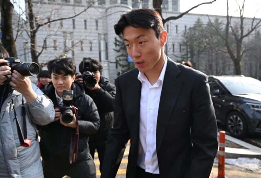 South Korean footballer Hwang Ui-jo leaves after receiving a sentence over his sex-video s