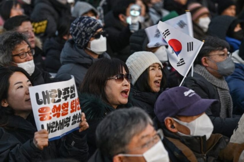 Seoul police estimated at least 200,000 people had gathered outside parliament in support