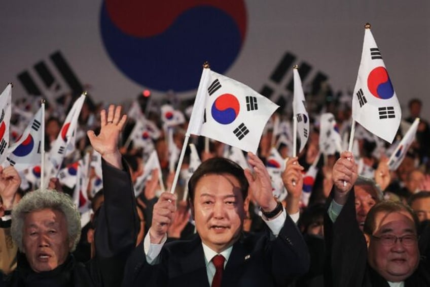 South Korean President Yoon Suk Yeol (C) called for the international community to back 'u