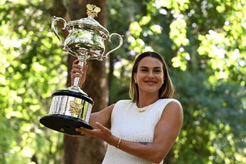 Aryna Sabalenka poses with the Australian Open trophy in Melbourne - now she wants more su