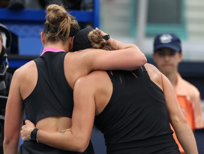 Aryna Sabalenka and Paula Badosa embrace at the net at the end of their Miami Open second