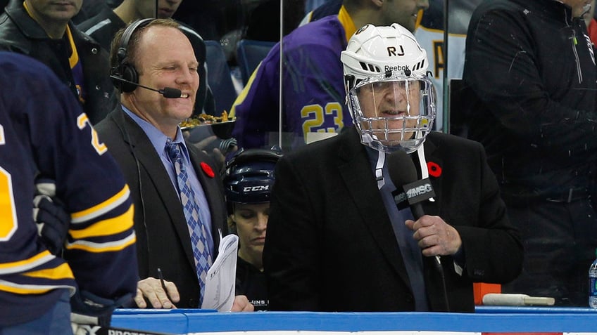 Buffalo Sabres former player Rob Ray and Sabres play by play man Rick Jeanneret announce the game between the Buffalo Sabres and the Los Angeles Kings in a box between the team at First Niagara Center on Nov. 12, 2013.