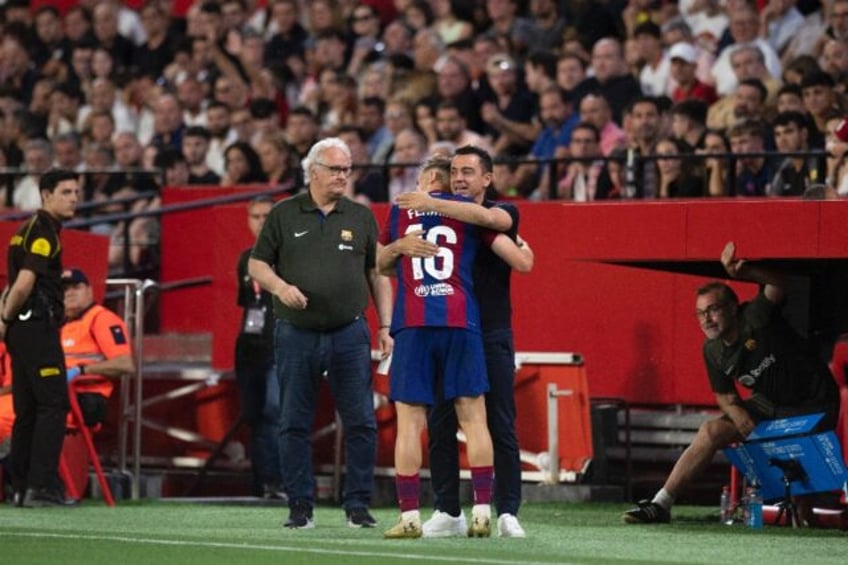 Barcelona's Spanish midfielder Fermin Lopez celebrates scoring his goal with departing coa