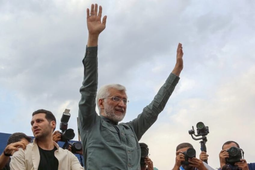 Ultraconservative former Iranian nuclear negotiator Saeed Jalili waves to supporters durin