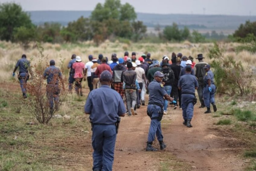 Police in South Africa have urged illegal miners to leave the old gold mine shaft