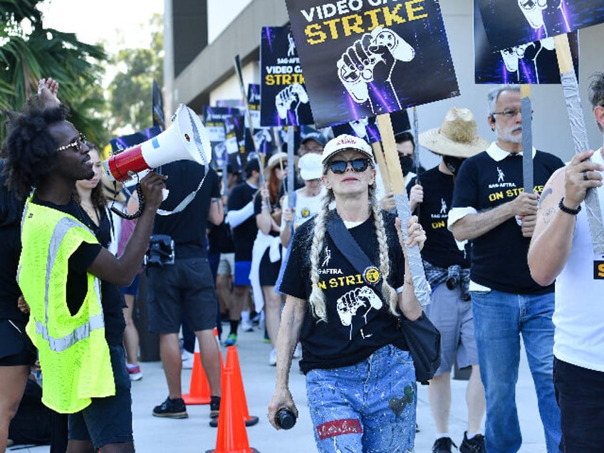 US actress Frances Fisher (C) strikes with SAG-AFTRA union video game performers outside W