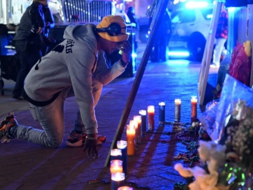 A man reacts at a memorial set up on Bourbon Street on January 2, 2025 in New Orleans, Lou