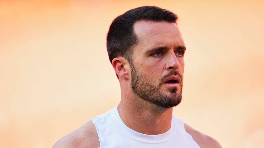 Derek Carr warms up before a game