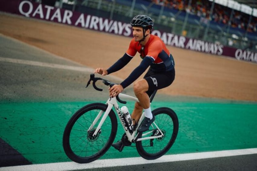 Pedal power: Carlos Sainz relaxing on a bike at Silverstone on Thursday as he stresses ove