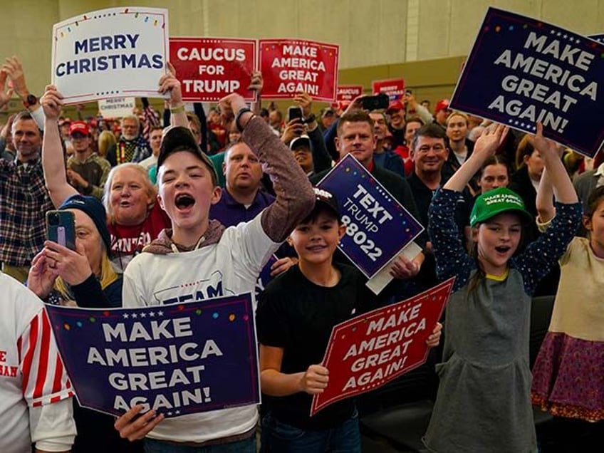 Audience members react as former President Donald Trump speaks during a commit to caucus rally, Tuesday, Dec. 19, 2023, in Waterloo, Iowa. (AP Photo/Charlie Neibergall)