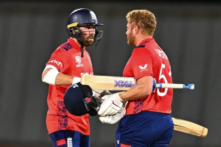 England's Phil Salt (left) and Jonny Bairstow celebrate the champions eight-wicket defeat