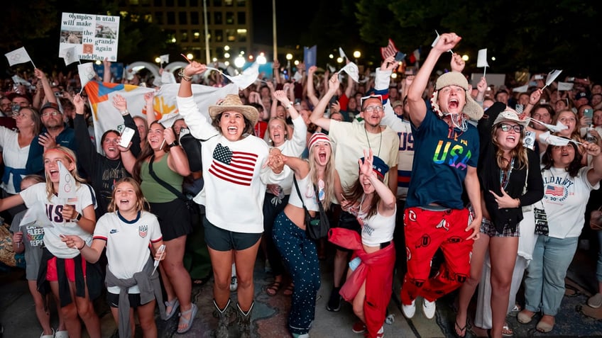 A crowd cheers at the announcement that Salt Lake City was chosen to hose the 2034 Winter Olympic Games.