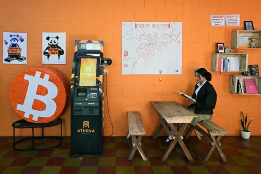 A student reads a book at the bitcoin community center in the mountain town of Berlin in E