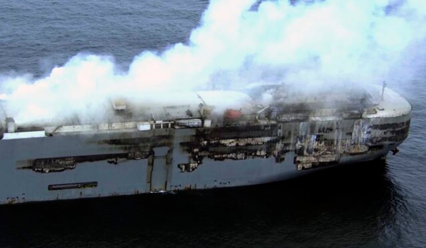 salvage crews begin towing a burning cargo ship to a new location off the dutch coast as smoke eases