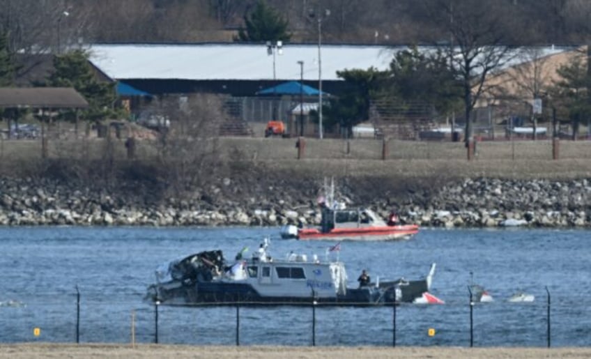 A police boat gathers wreckage along the Potomac River after American Airlines flight 5342